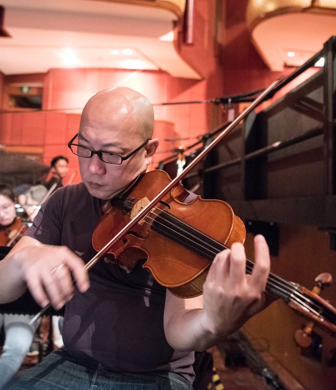 Han Oh performing on viola during a classical ensemble rehearsal
