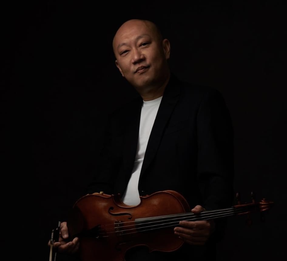 Han Oh seated, holding a viola
